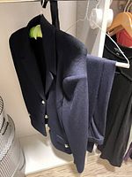 Navy knit blazer and matching pants on hanger