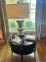 Overall view of side table, lamp, books and bird accents