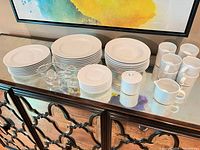 Full set displayed on sideboard showing plates, bowls, mugs, sugar, creamer, gravy boats, ladles