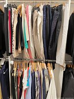 Upper rack showing assorted women’s trousers in multiple colours and fabrics