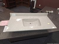 Full view of vanity top showing integrated sink and backsplash