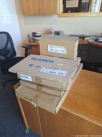 Stack of six Blanco accessory cartons