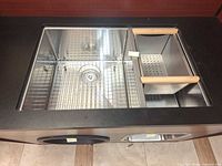 Top view of sink showing double bowls, bottom grid and colander insert