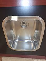 Full view of stainless steel single bowl sink mounted in display