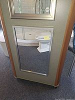 Cabinet exterior showing mirrored door and satin silver frame