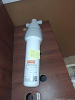 Full view of filter cartridge assembled in housing on display shelf, sticky note marked 41 attached