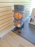 Front view of pumpkin-headed resin statue