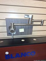 Front view of Huntington Brass pot filler faucet mounted on display board