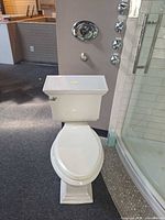 Front view of Kohler white two-piece elongated toilet on display