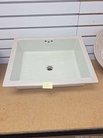 Top view of rectangular Kohler sink showing rim, basin and drain opening
