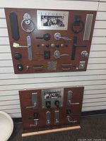 Two display boards mounted with assorted LaForge door hardware pieces