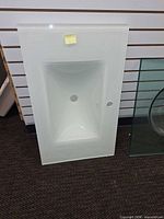 Front view of glass vanity top showing integrated sink and faucet hole