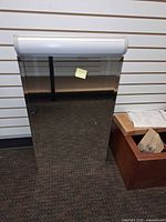 Front view showing mirrored door and attached light fixture