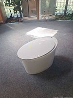 Front angled view of white smart toilet with lid closed