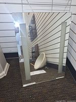 Front view of mirror showing frosted side light panels and frameless edges