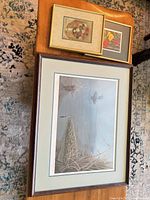 All three framed artworks grouped: large loon print beneath two smaller floral pictures