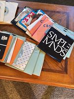 Stacks of 45 rpm singles on coffee table showing various sleeves