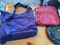 purple Lug bag and red crossbody purse