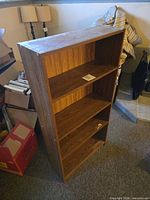 Front view showing four shelves and woodgrain finish