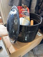 Canner with lid open showing accessories