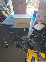 Auto-Vox monitor, box and power plug visible