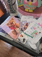 Table view showing instruction book, patterns, safety eyes, edge of stuffing bag