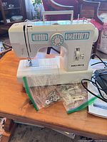 Euro-Pro X model 392 sewing machine with accessories in plastic bags and power/foot pedal cords