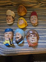 All seven character head plaques laid out