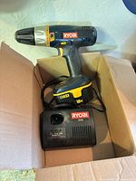 Ryobi 18V cordless drill with battery and charger inside box