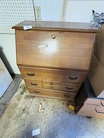Front view of secretary desk showing drop front and drawers