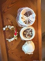 Overview of four vintage headwear pieces on table