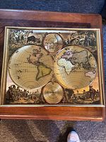 Front view of framed gold foil world map print