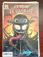 Extreme Venomverse #4 variant with Ken Lashley signature visible on cover in blue ink, bagged and boarded