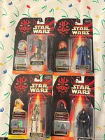 All four sealed carded figures on patterned surface