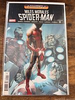 Front view of bagged Miles Morales: Spider-Man #0 comic showing full cover art and signature