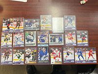 All 18 sleeved/top-loaded Young Guns cards displayed on table