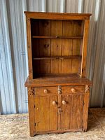 full view of cupboard front showing upper shelves and lower cabinet