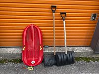 Front view of sled and two shovels