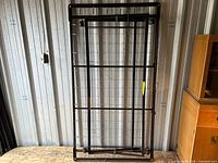 Full front view of trundle bed frame standing upright