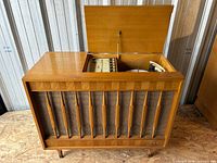 Console front with lid open showing radio tuner and record player