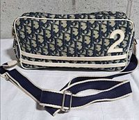 Front view showing Diorissimo monogram, leather numeral appliqué, horizontal leather trim and adjustable strap