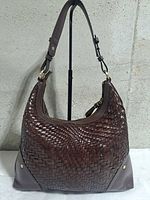 Front view of brown woven leather Cole Haan Genevieve hobo bag