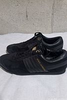 Side view of both shoes showing leather, suede panels and Dolce & Gabbana side logo