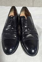 Front view of both shoes showing cap toe and lacing