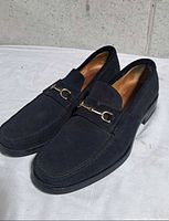 Top angled view of both loafers showing suede material and horsebit detail
