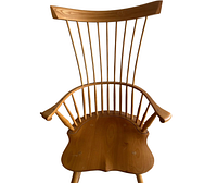 Front view showing spindle back, continuous arms, sculpted seat
