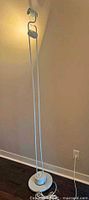 Full view of white metal floor lamp