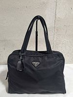 Front view showing Prada triangle logo and overall exterior condition