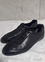 Left side view of both shoes showing leather upper, stitching, and overall condition