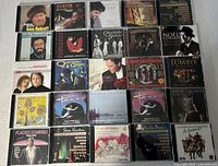 All 25 CD cases laid out in four-row grid
